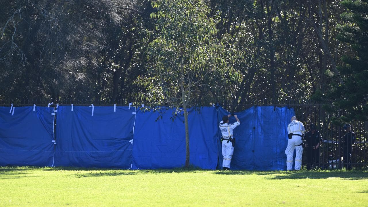 A NSW Police cordon off the scene on the banks of the Cooks River
