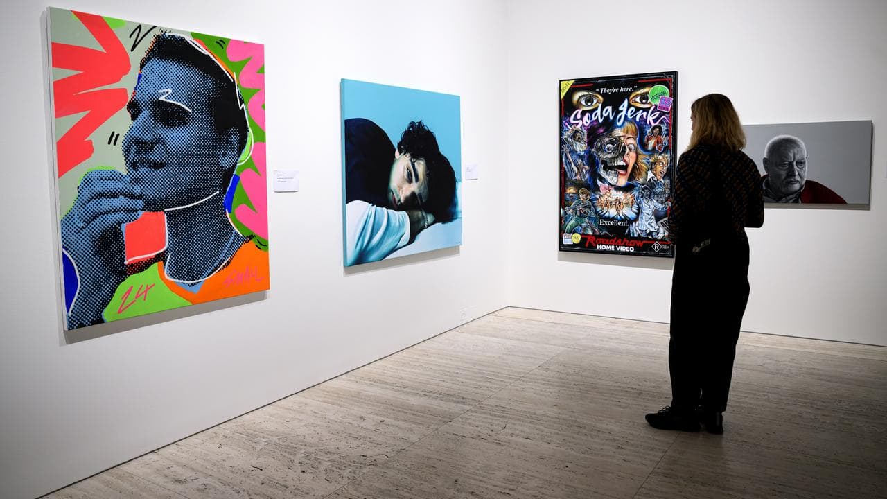 People walk through the Archibald Portrait Prize exhibition