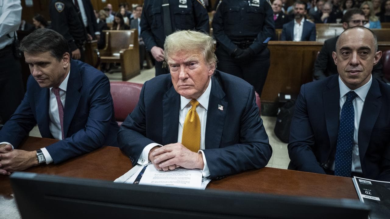 Former president Donald Trump sits in Manhattan Criminal Court