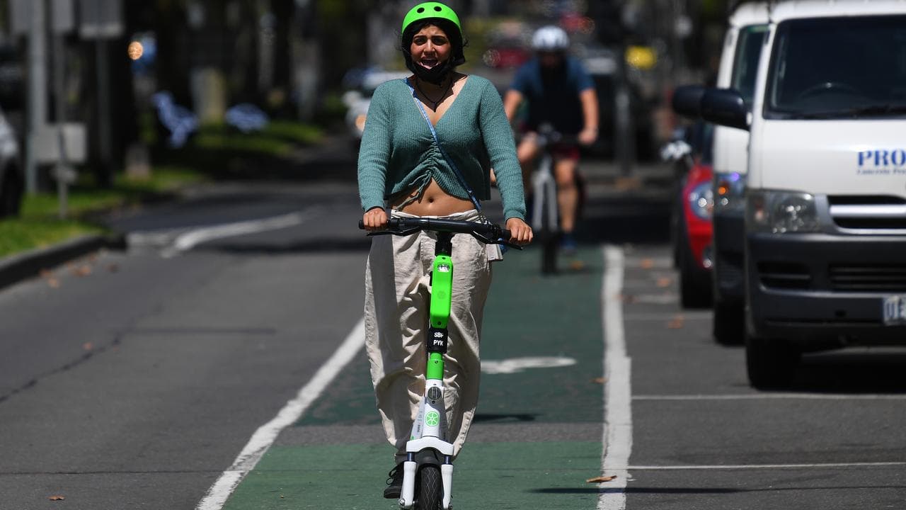 People riding Lime electric assist scooters in Melbourne