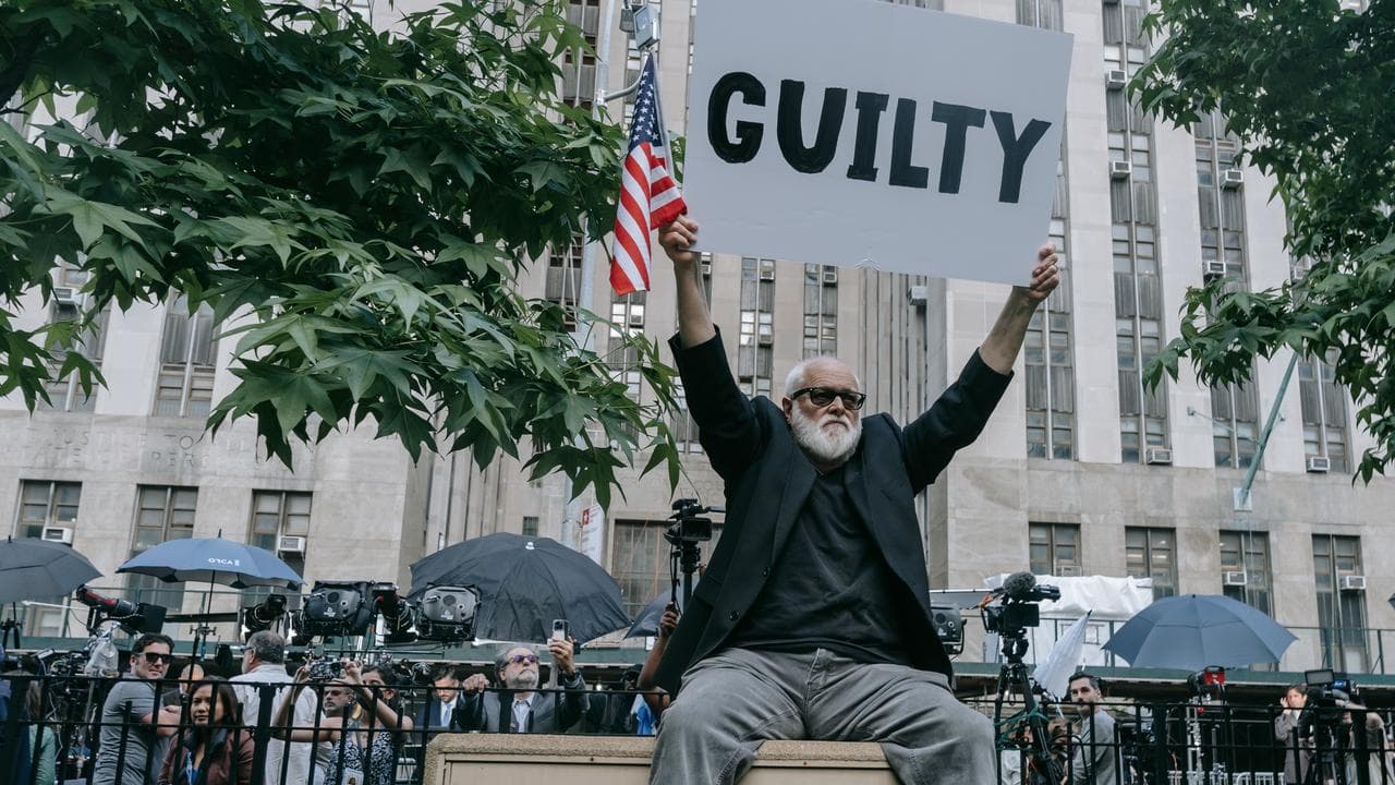 An Anti-Trump protester reacts outside the courthouse