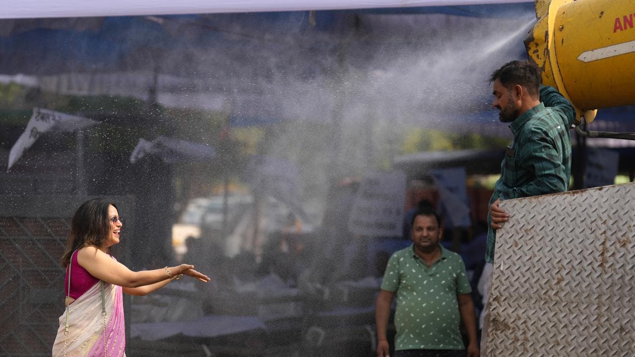 Woman being sprayed with water in India
