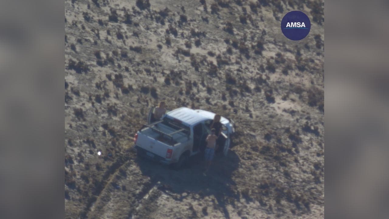 The three teens beside the stricken 4WD