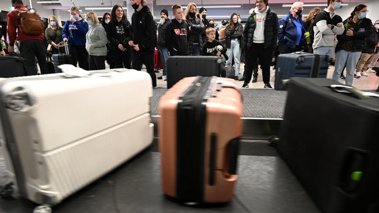 Travellers wait at a baggage claim carousel at Melbourne Airport