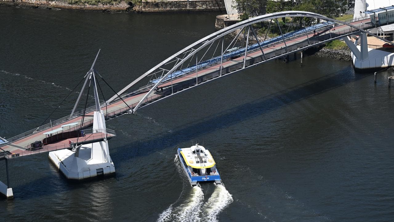 A ferry goes under a bridge on the Brisbane River.