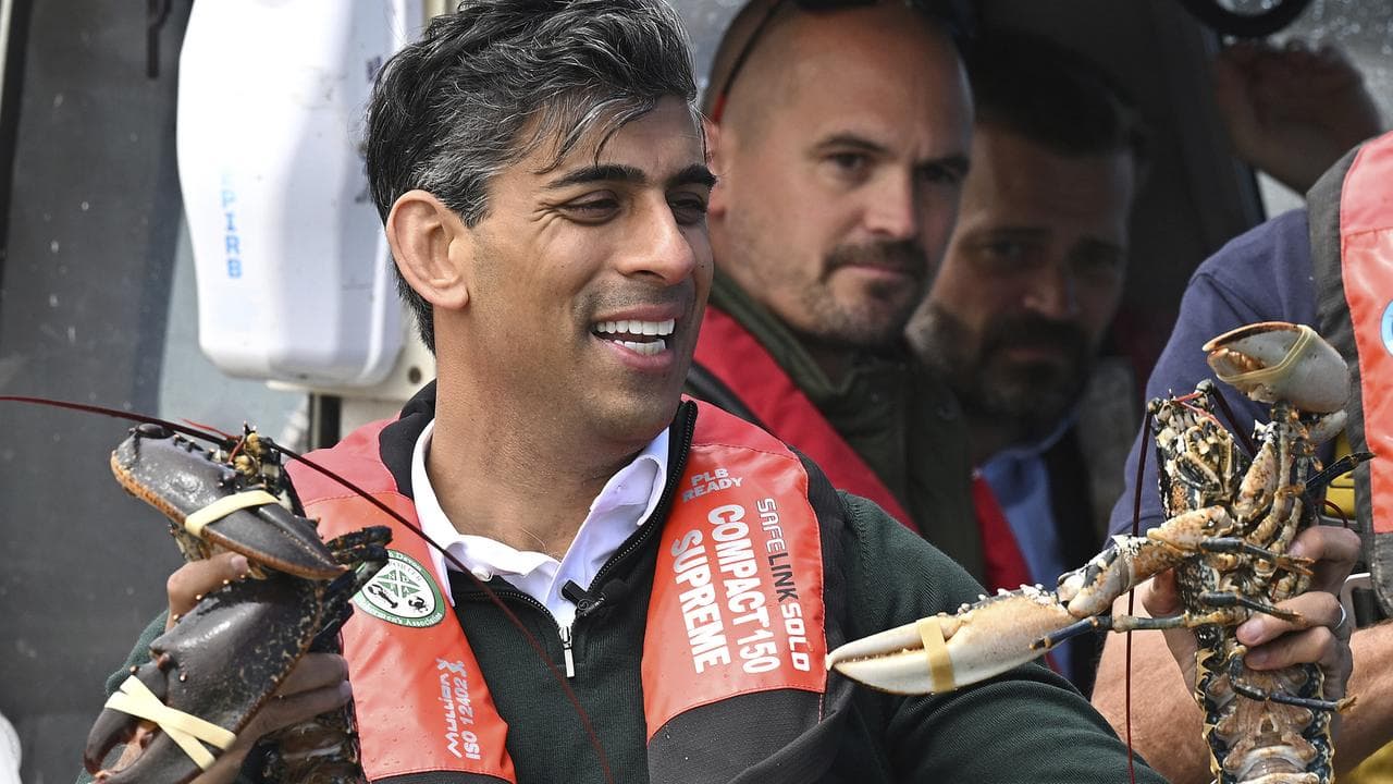 UK Prime Minister Rishi Sunak rides on a boat at Clovelly, England