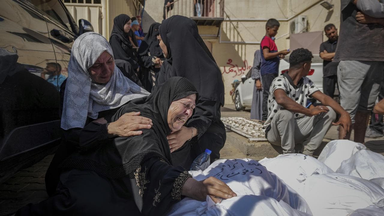 Palestinians mourn their relatives in a hospital in Deir al Balah