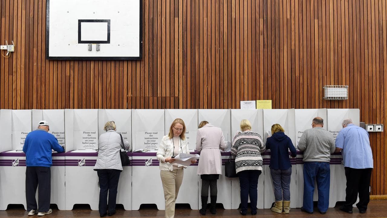 Voters fill out their ballots