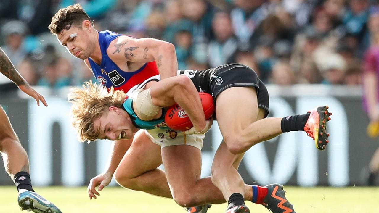 Lachie Neale tackled Port Adelaide's Miles Bergman