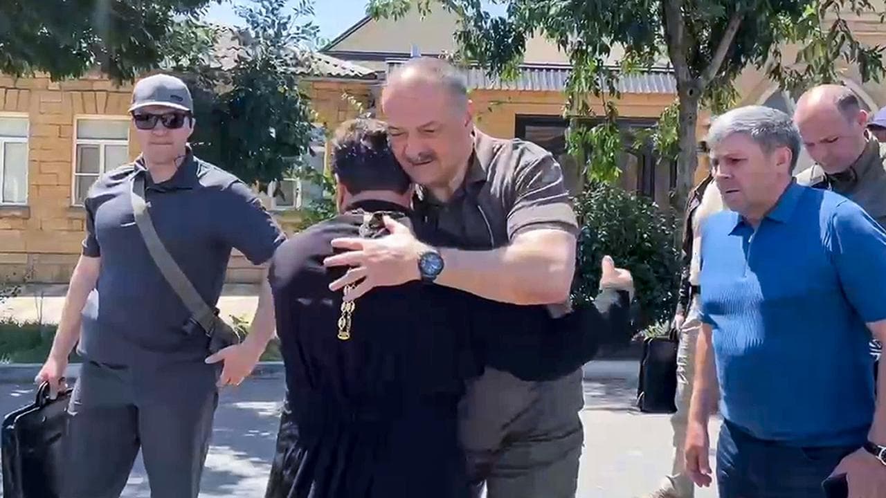 Dagestan leader Sergei Melikov greets a priest in Derbent