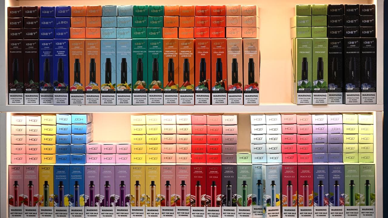 Brightly coloured vapes on a store shelf. 