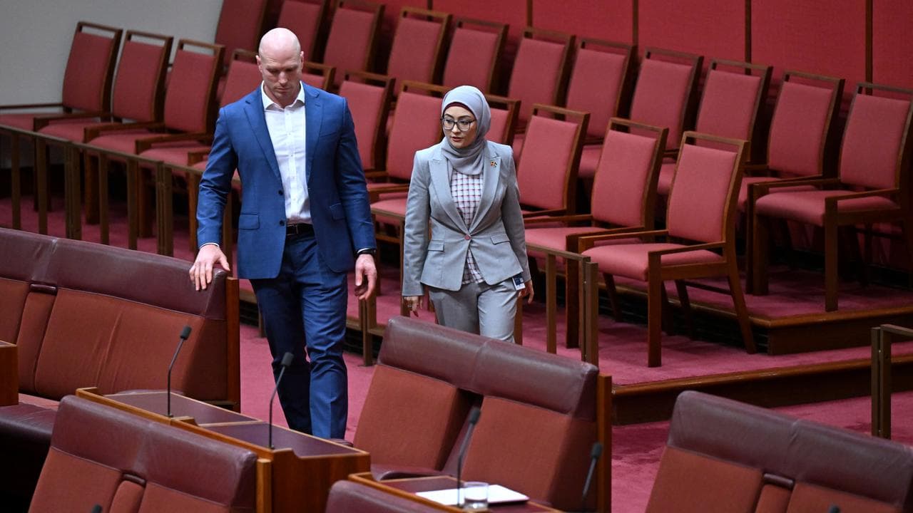 Two senators cross the floor to vote.