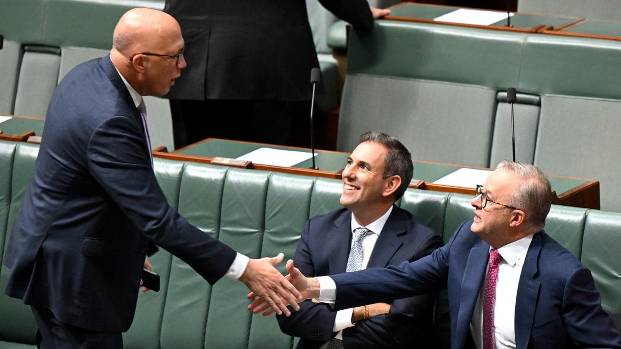Anthony Albanese and Peter Dutton shake hands during a debate.