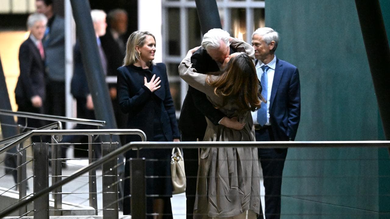 Julian Assange kisses his wife Stella Morris. 