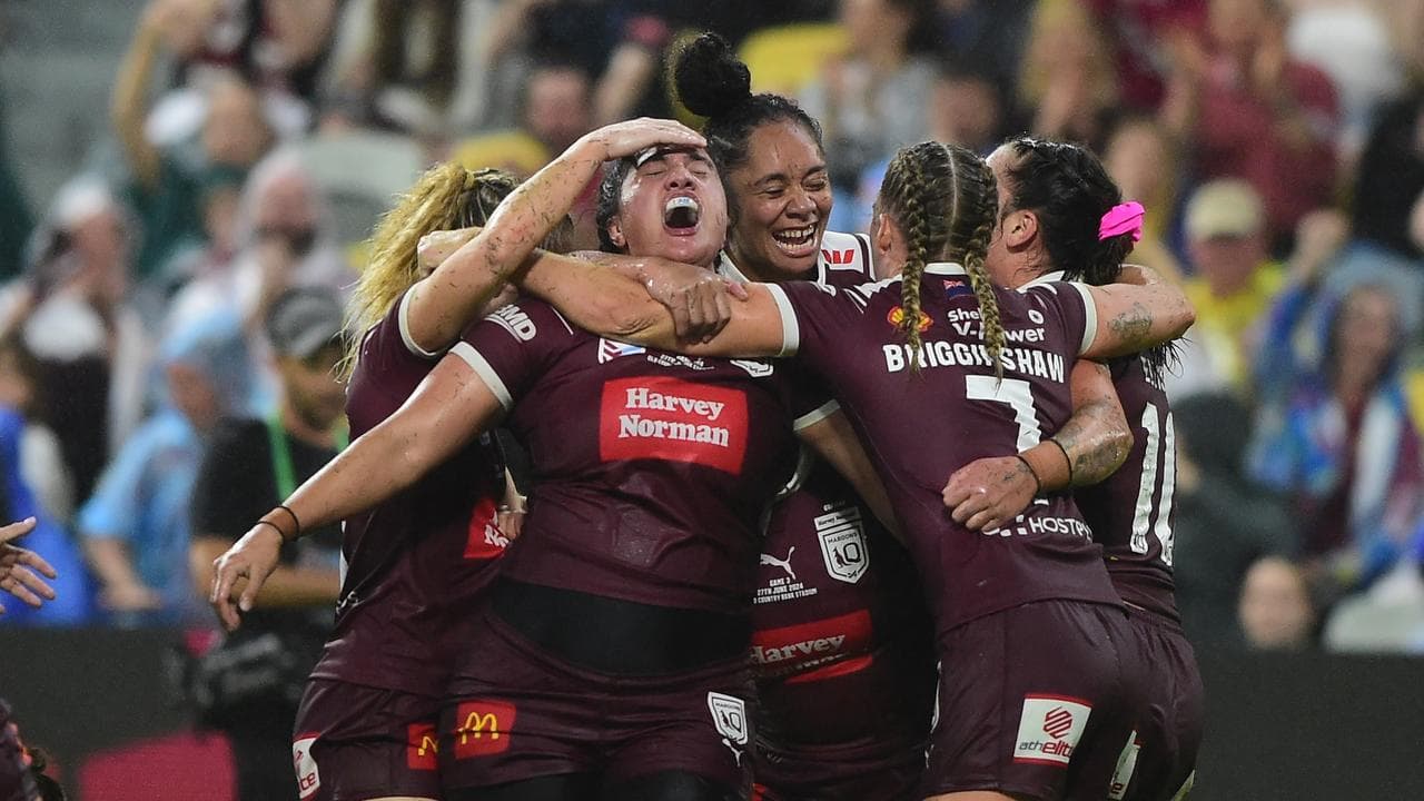 Tazmin Rapana (centre) celebrates her late try for Queensland.