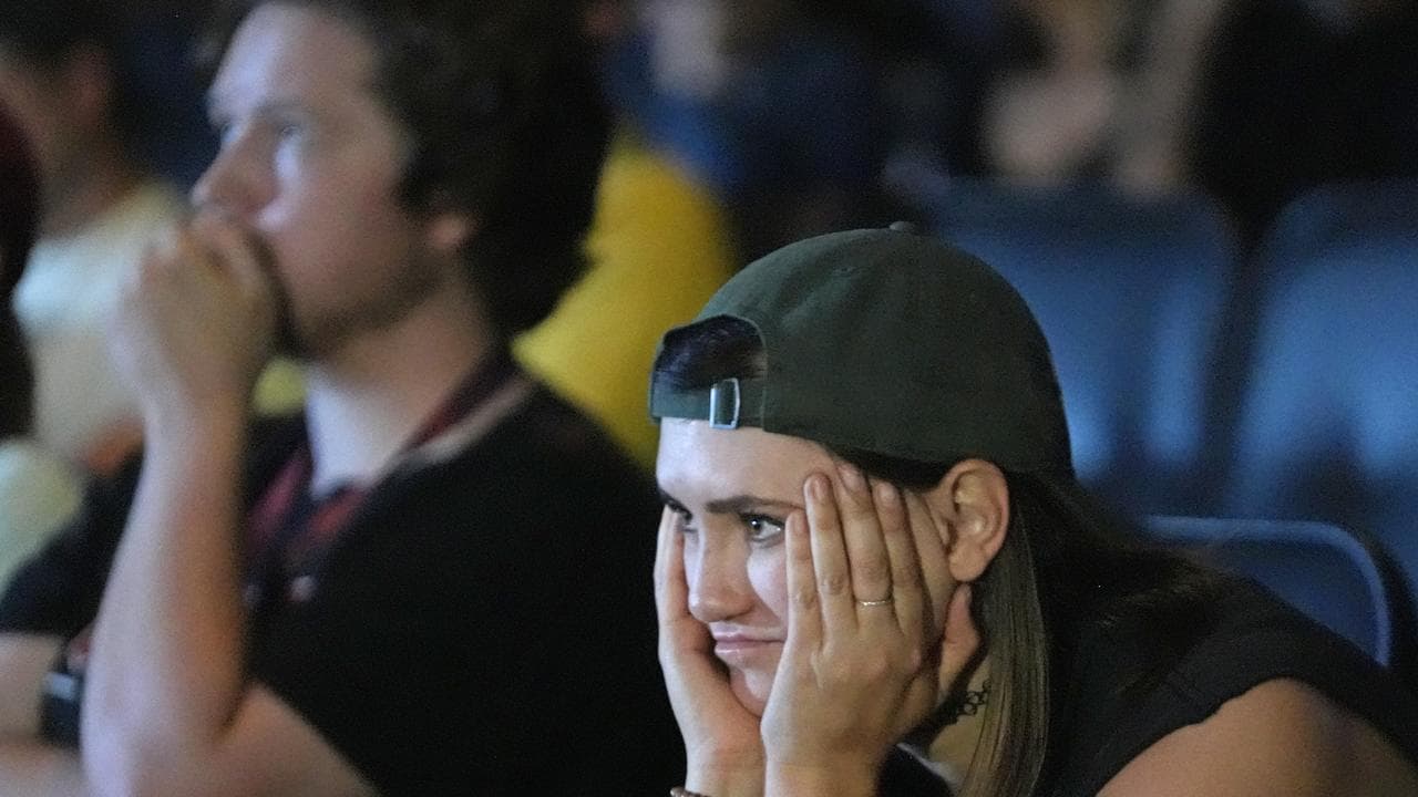 A supporter of President Joe Biden watches coverage of the debate