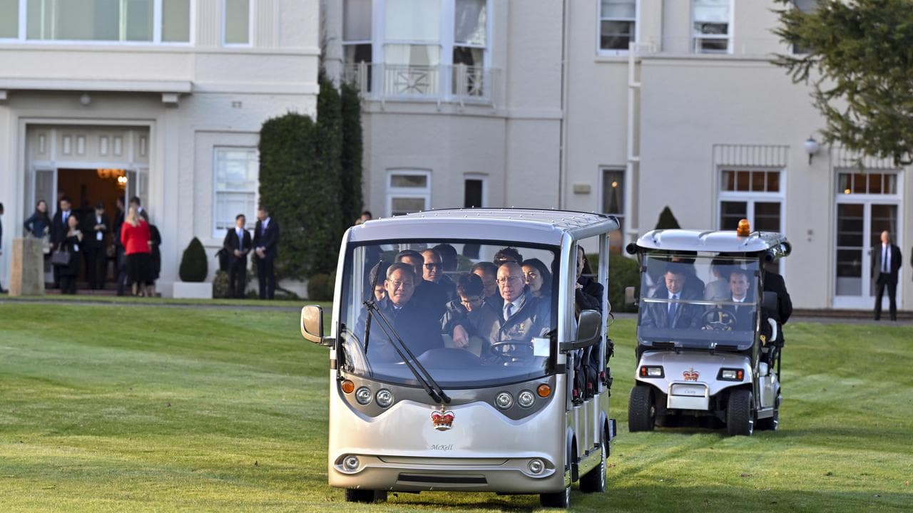 People drive golf buggies at Government House.