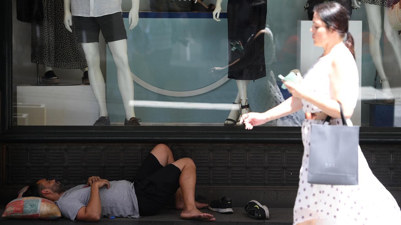 A man is seen sleeping on the street