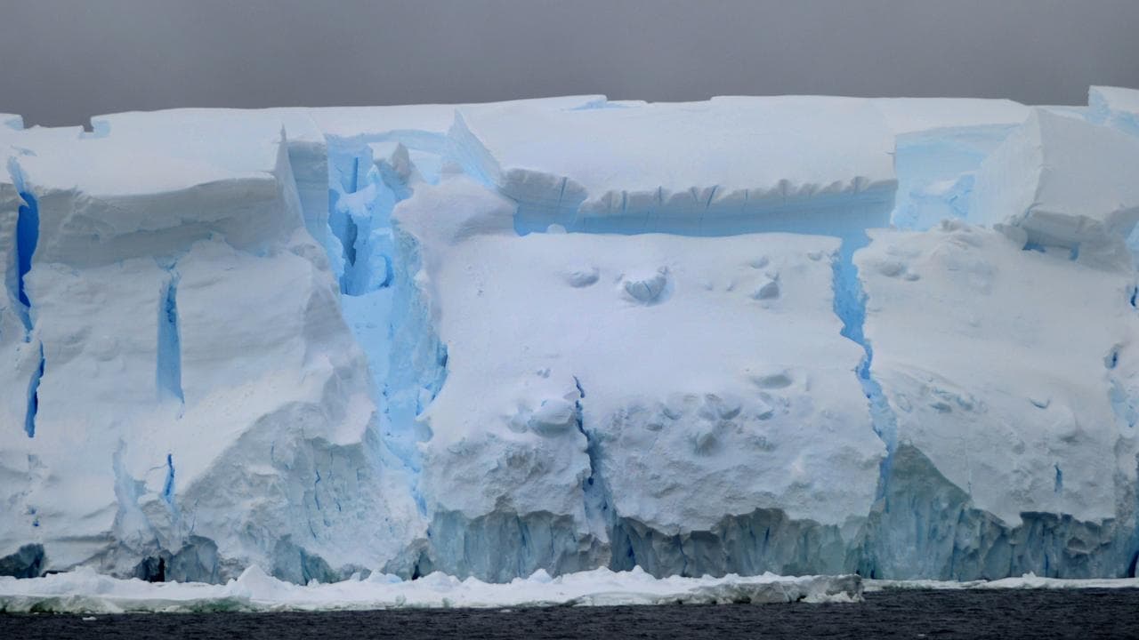 Pack ice and huge icebergs calving in Antarctic waters 