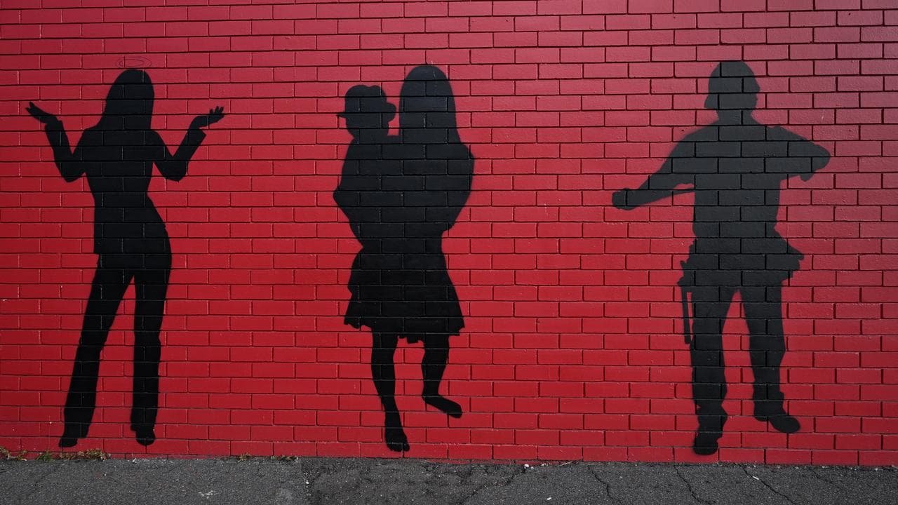 A wall with silhouetted artwork