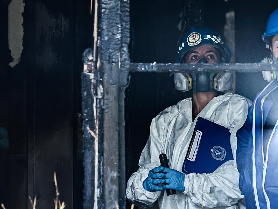 Forensic officers investigate a fire damaged house in  Sydney