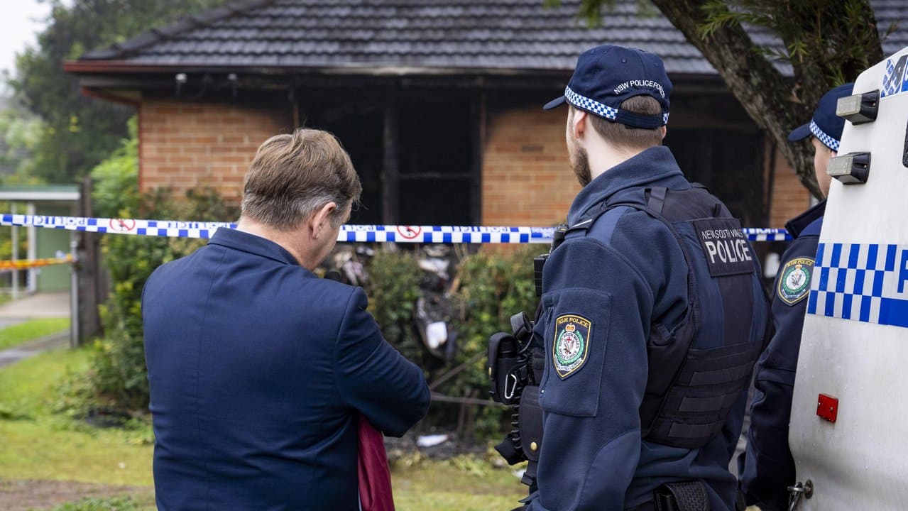 Police are seen at the site a fatal house fire at Lalor Park