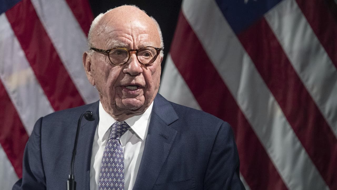 Rupert Murdoch in front of US flags in New York