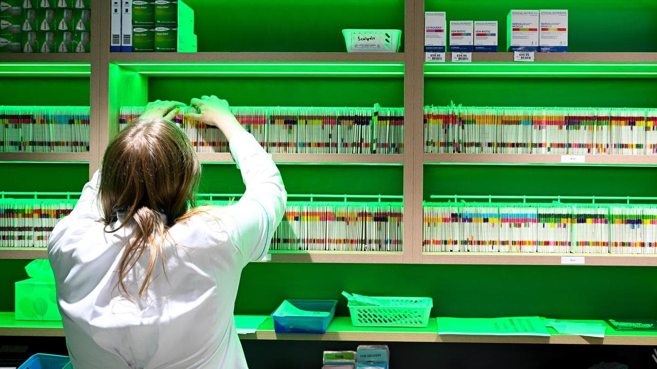 A pharmacists prepares scripts