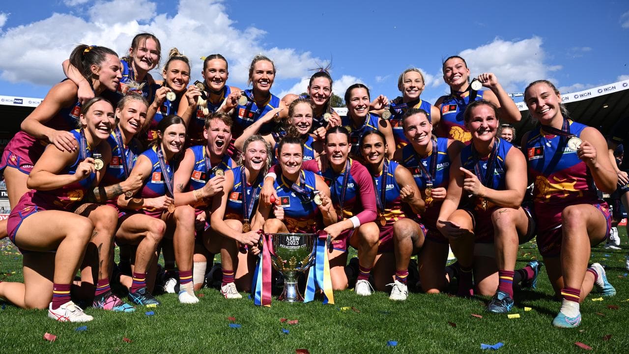 Brisbane Lions players celebrate winning the AFLW decider.
