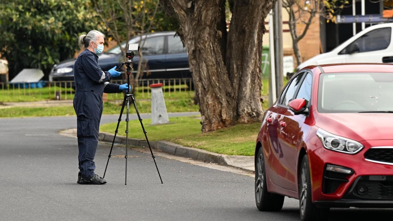 A forensic investigator near the home that's now a crime scene