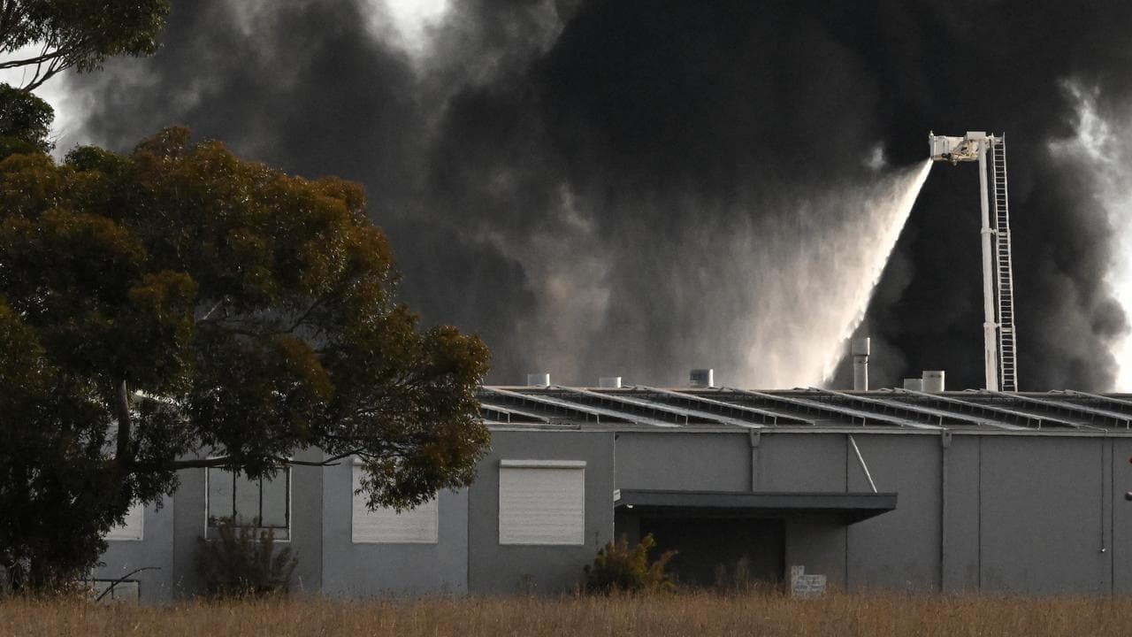 Firefighters battle a large factory