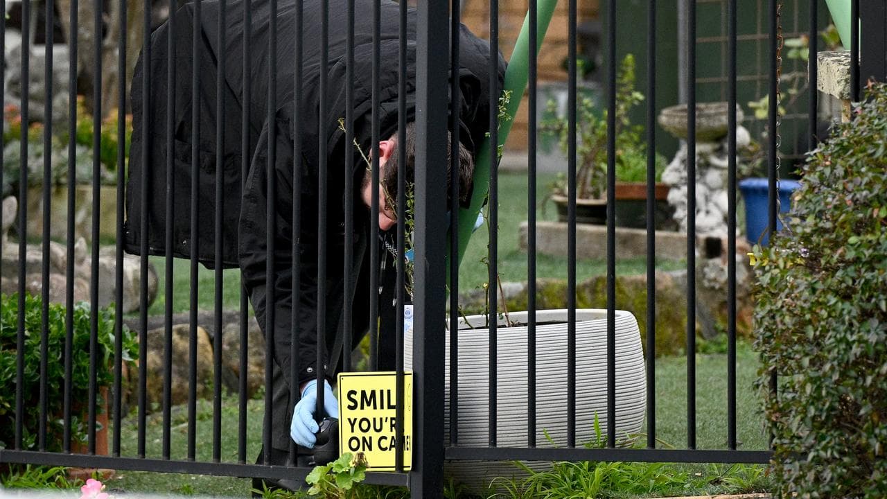 Detective inspects crime scene where two bodies were found