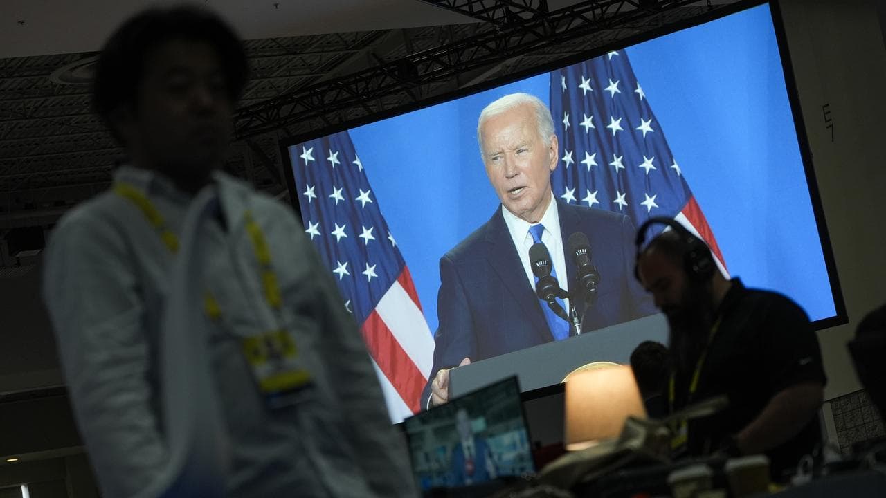 A screen shows US President Joe Biden's news conference