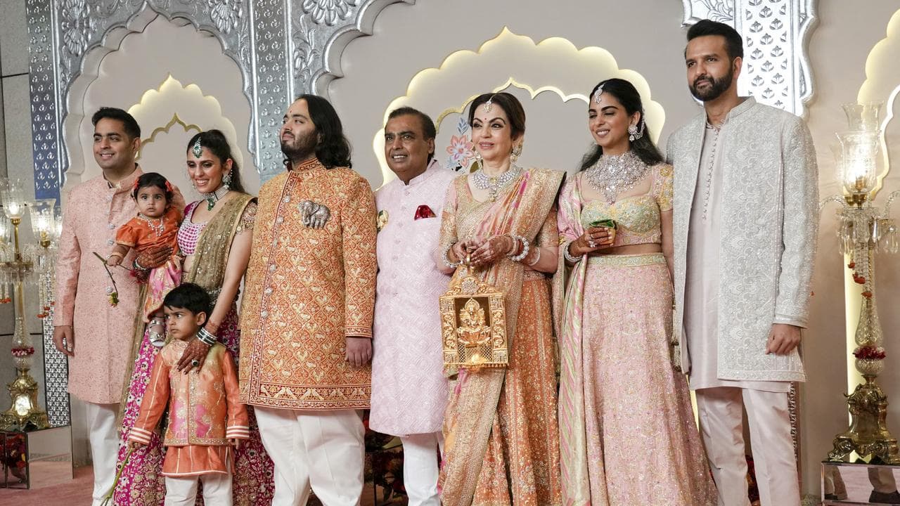 Billionaire Mukesh Ambani poses with family at his son Anant's wedding