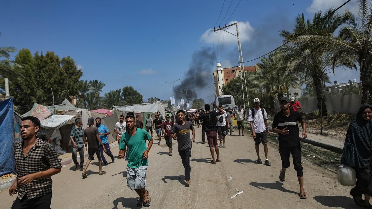 Palestinians flee after an Israeli raid in Khan Younis