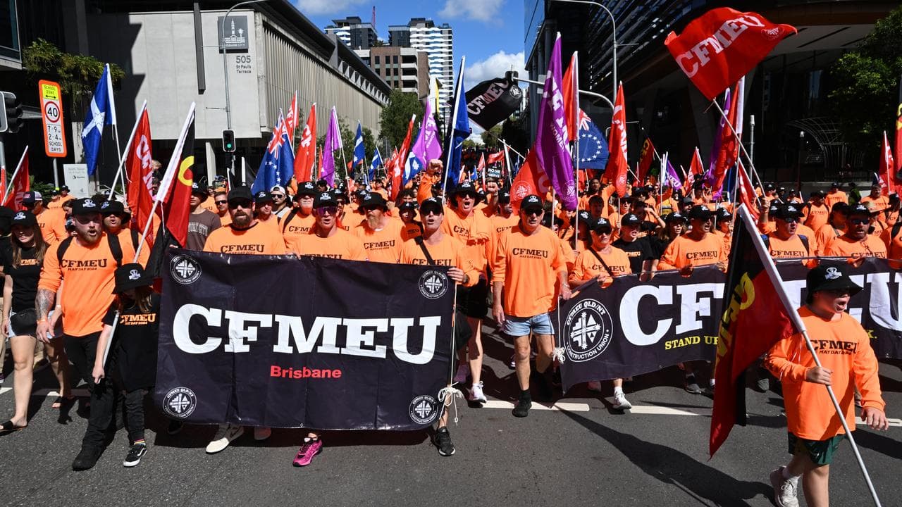 Members of the CFMEU and other people participate in a march