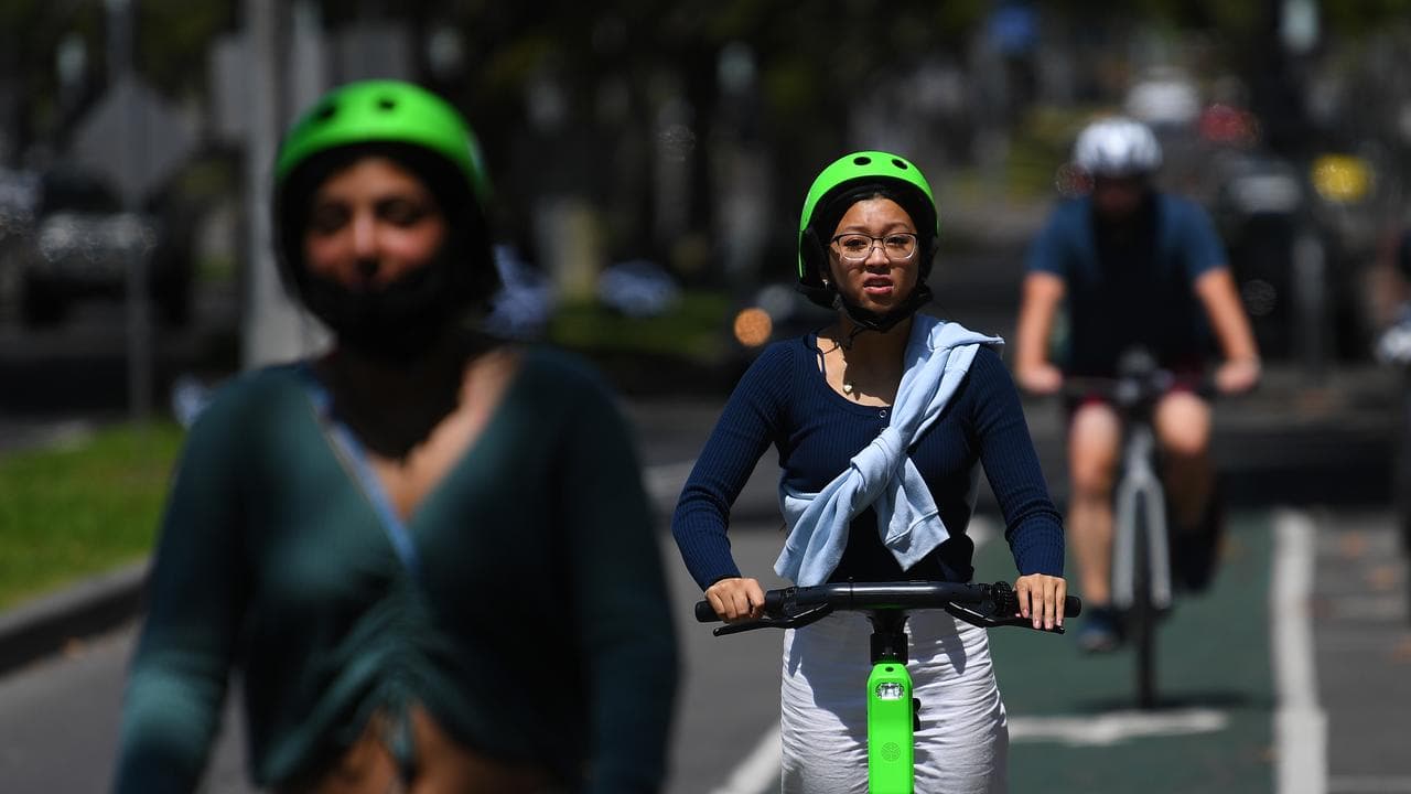 People riding Lime electric assist scooters