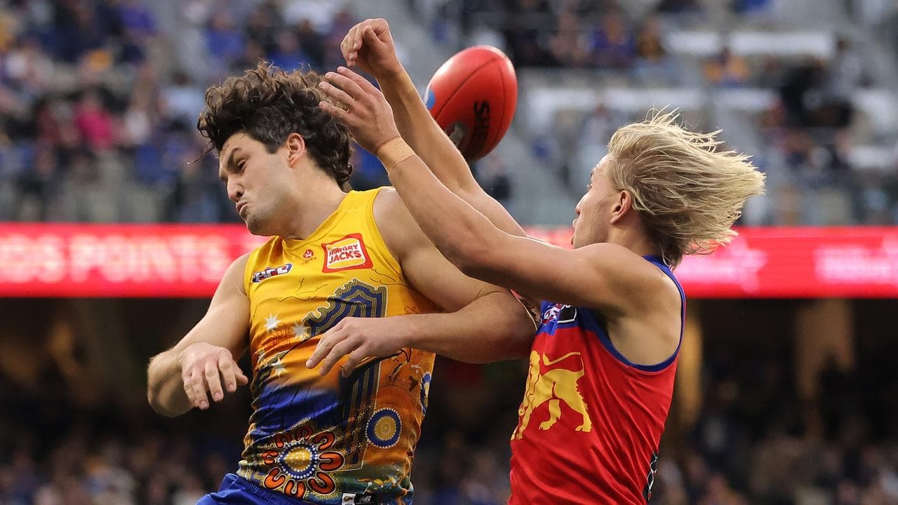 West Coast's Tom Barrass (left) and  Brisbane's Kai Lohmann.