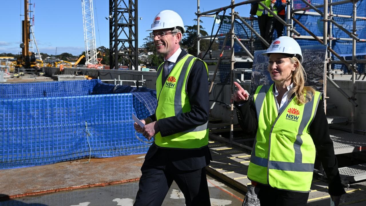 Two people tour a construction site.