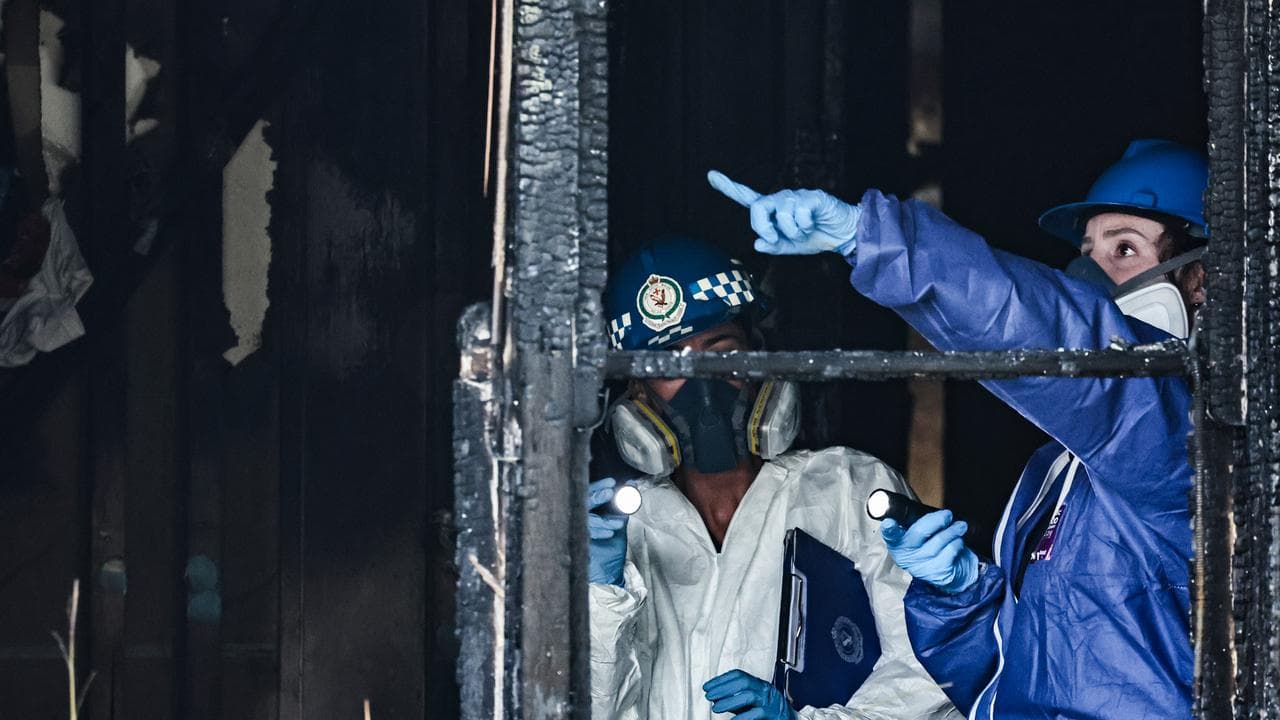 Police investigate a fire damaged house in Lalor Park in Sydney