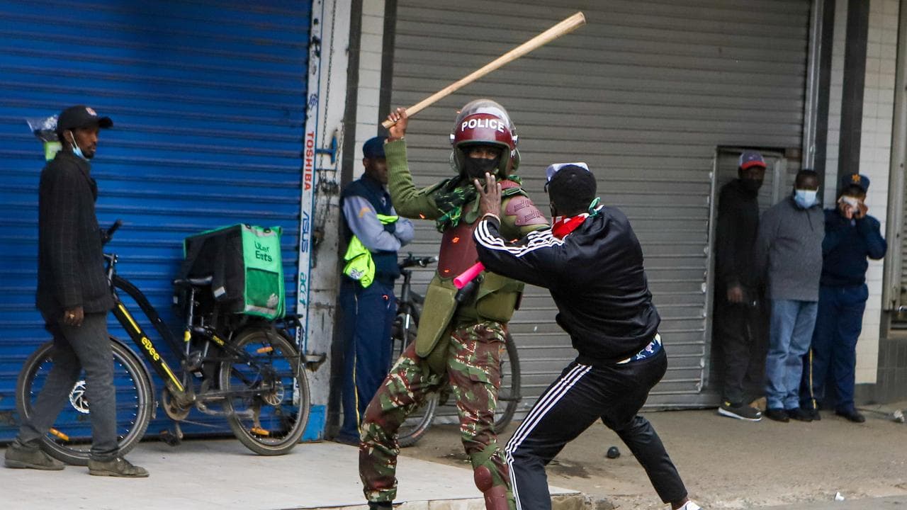 Protester clashes with a police officer