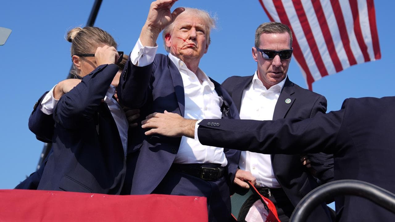 Photos from the sequence show Trump without a bullet hole .