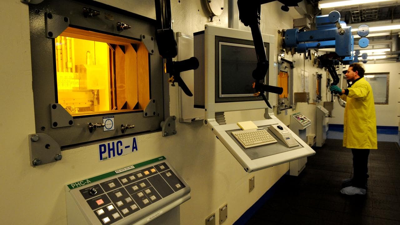 A technician uses a hot cell at Lucas Heights.