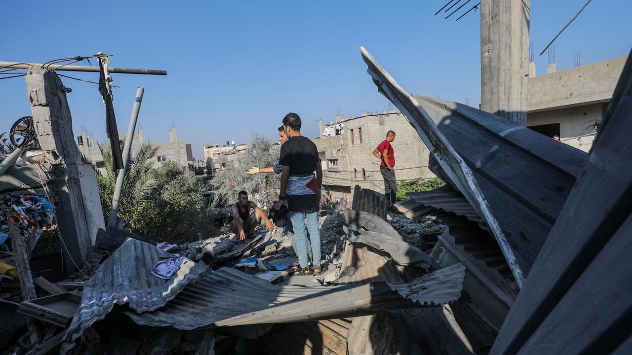 Palestinians after an Israeli air strike in the central Gaza Strip