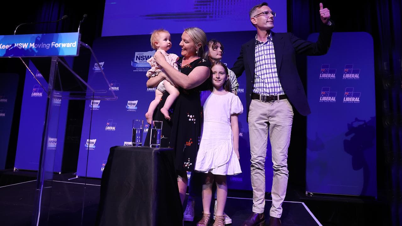 Dominic Perrottet on stage with his family.
