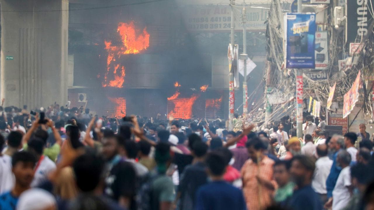 Protesters set a police box on fire in Dhaka, Bangladesh