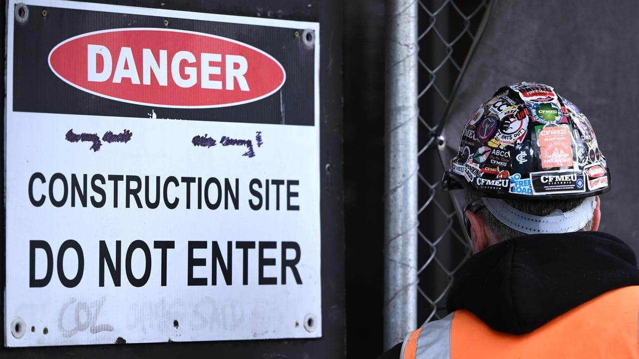 CFMEU stickers on a worker's hard hat