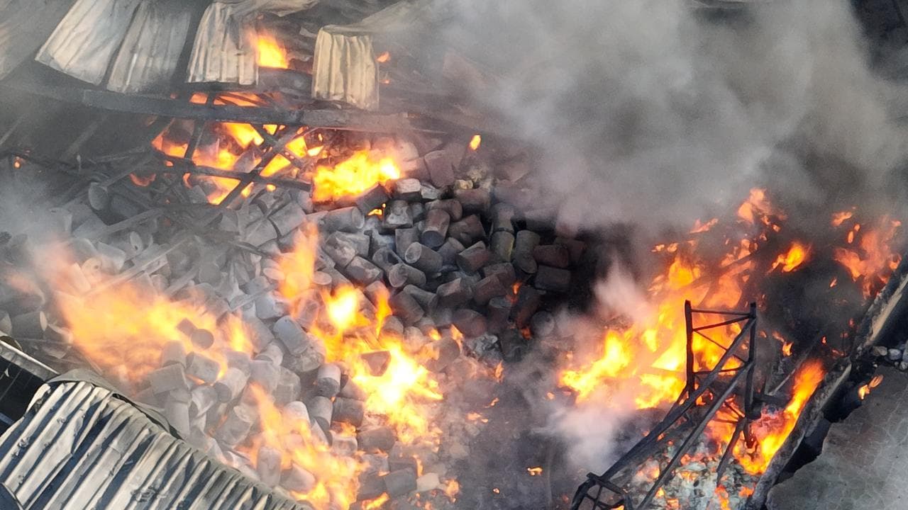A drone image shows chemical drums inside a Derrimut factory fire