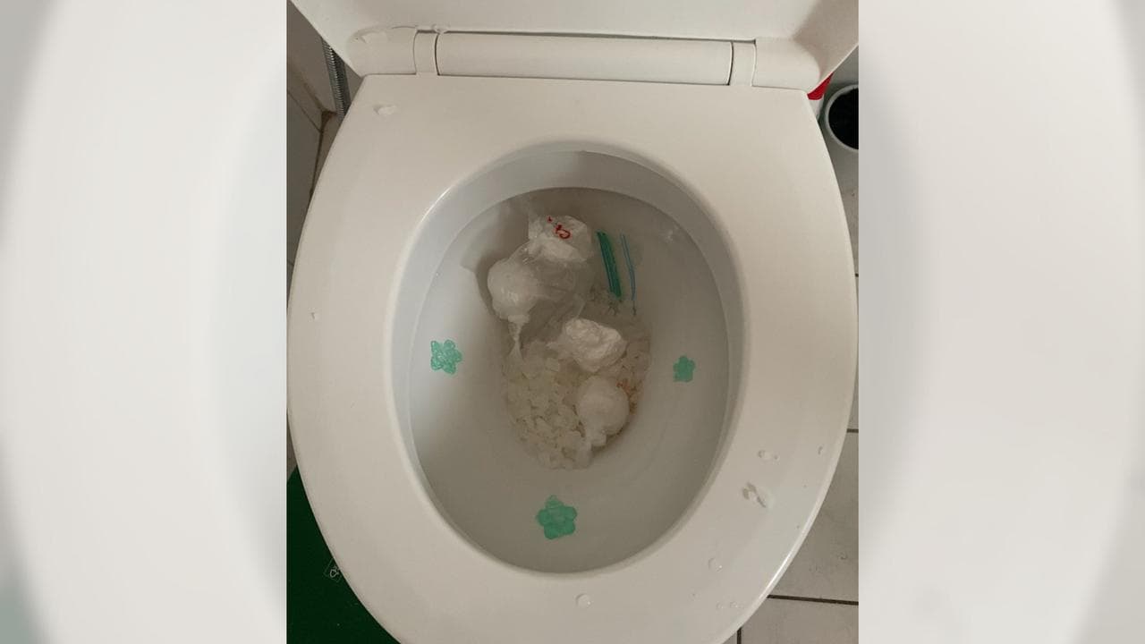 Packages allegedly containing methylamphetamine and heroin in a toilet
