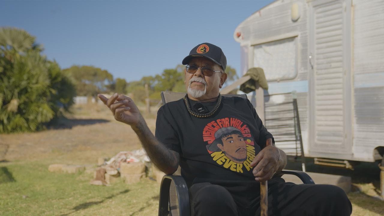 A man sits in a wheelchair.